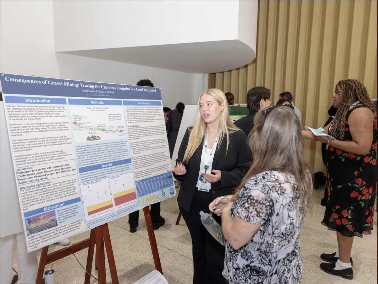Anna Callens presenting her gravel-mining research poster to a judge at the 2026 GCSE International Science Fair in Panama